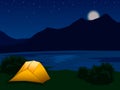 Night mountain landscape with illuminated orange tent. Royalty Free Stock Photo