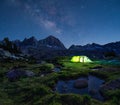 Night mountain landscape with illuminated tent. Royalty Free Stock Photo