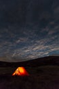 Night mountain landscape with illuminated tent Royalty Free Stock Photo