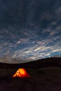 Night mountain landscape with illuminated tent Royalty Free Stock Photo