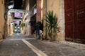 Night narrow street of old town center, decorated with flower pots. Royalty Free Stock Photo