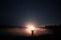 Night near lake with man's silhouette