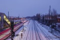 Night top view over platform railway station, railway track covered by snow in winter. Royalty Free Stock Photo