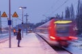 Night outdoor view on platform railway station in winter in Germany. Royalty Free Stock Photo