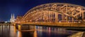 Night panorama of the illuminated Hohenzollern bridge over Rhine river. Beautiful cityscape of Cologne, Germany with cathedral Royalty Free Stock Photo