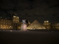 Night panorama of Louvre pyramid glass design architecture museum building construction in Paris France Europe