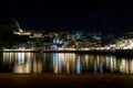 Night Panormic View of Parga Town, Greece. Famous Tourist Resort with Illuminated Houses and Sea that Reflects the Lights