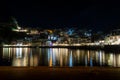 Night Panormic View of Parga Town in Greece. Famous Tourist Resort with Traditional Houses and Sea that Reflects the Lights