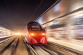 Night passenger high-speed train passing the station in the city Royalty Free Stock Photo