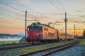 Night passenger train from Prague to Rijeka on its way over the Ljubljana marshes in early romantic morning with sunrise. Fast