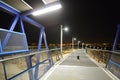 Night pedestrian bridge over the highway in Orihuela Costa. Royalty Free Stock Photo