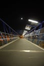 Night pedestrian bridge over the highway in Orihuela Costa. Royalty Free Stock Photo
