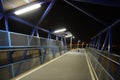 Night pedestrian bridge over the highway in Orihuela Costa. Royalty Free Stock Photo