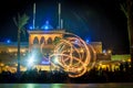 Night performance fire show in front of a crowd of people