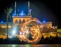 Night performance fire show in front of a crowd of people