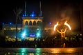 Night performance fire show in front of a crowd of people