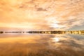 Night photo of clouds mirror reflected at Swedish countryside lake, moon shines behind clouds and gives unreal colors Royalty Free Stock Photo