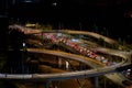 Night photo of a glowing multi-level road junction with heavy traffic. Roads in the metropolis