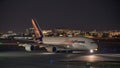 Night photo of a Lufthansa airplane at Miami International airport taxxing