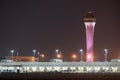 Night photo Miami International Airport control communications tower lit purple