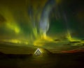 Night photo. Northern lights and a small house in the land overgrown with grass. Iceland. Royalty Free Stock Photo