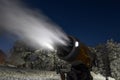 Night photo of snow cannon or snowmaking machine in action in ski resort. Royalty Free Stock Photo