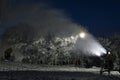 Night photo of snow cannon or snowmaking machine in action in ski resort. Royalty Free Stock Photo