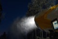 Night photo of snow cannon or snowmaking machine in action in ski resort. Royalty Free Stock Photo