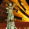 Night photo of statue of Lady Justice, known as the Roman goddess of Justice