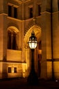 Night photo of a street lantern in front of the Parliament building in Budapest