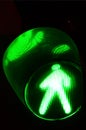 Night photo of a traffic light for pedestrians, which lights up in green Royalty Free Stock Photo