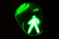Night photo of a traffic light for pedestrians, which lights up in green Royalty Free Stock Photo
