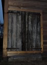 Barn doors on an old barn highlighted at night by a flash