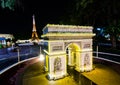 Night photography of The Arc de triomphe Paris at miniature park is an open space that displays miniature buildings and models.