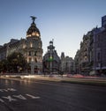 Night photography light trails top view edificio metropolis at the corner of calle de alcala and gran via madrid