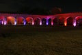 Night photography, view of the hacienda construction with stone arches and colored lighting