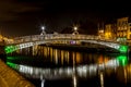 Night picture of the river liffey and Ha penny bridge Dublin Ireland reflections Royalty Free Stock Photo