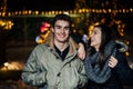 Night portrait of a happy couple smiling enjoying winter and snow aoutdoors.Winter joy.Positive emotions.Happiness Royalty Free Stock Photo