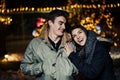 Night portrait of a happy couple smiling enjoying winter and snow aoutdoors.Winter joy.Positive emotions.Happiness Royalty Free Stock Photo