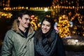Night portrait of a happy couple smiling enjoying winter and snow aoutdoors.Winter joy.Positive emotions.Happiness Royalty Free Stock Photo