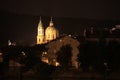 Night in Prague and domes of two churches in the light.