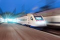 Night railway station, a passing train at speed Royalty Free Stock Photo