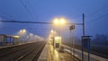 Night railway terminal. Deserted train station in fog. Concept of travelling, tourism or commuting to work