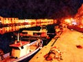 The night riverside of a small town in Sardinia in Italy. Digital painting.