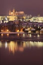 Night romantic colorful snowy Prague gothic Castle with Charles Bridge Royalty Free Stock Photo