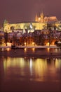 Night romantic snowy Prague gothic Castle and St. Nicholas' Cathedral, Czech republic Royalty Free Stock Photo