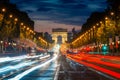 Night scence illuminations traffic street of the Impressive Arc de Triomphe Paris along the famous tree lined Avenue des Champs- Royalty Free Stock Photo