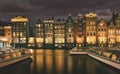 Night scene of Amsterdam City with amazing architecture and boats by the canal Royalty Free Stock Photo