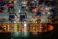 Container ship loading and unloading in deep sea port, Aerial view at night Royalty Free Stock Photo