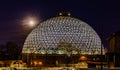 Night scene of the Desert Dome, with the moon riding on the side, at Henry Doorly Zoo Omaha Nebraska. Royalty Free Stock Photo